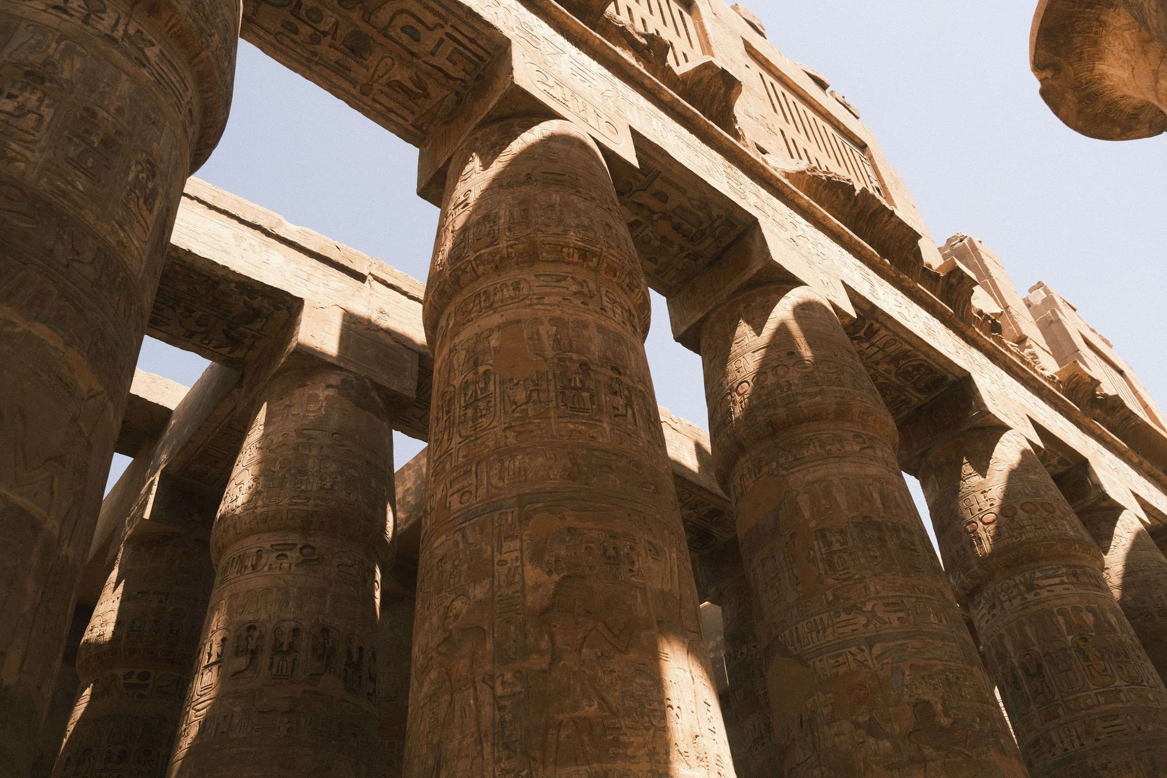 Ancient columns and carved stone lintels at Karnak Temple in Luxor.